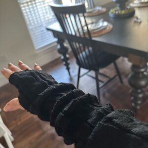 Black cable knit fingerless gloves.